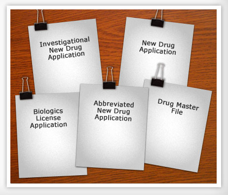 Five documents lying on a conference table on top of each other with the following titles:

Investigational New Drug Application 
New Drug Application 
Biologics License Application 
Abbreviated New Drug Application 
Drug Master File