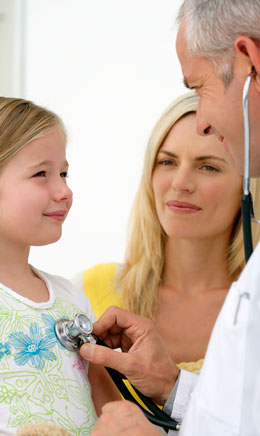 a doctor examines a child with a stethoscope