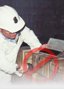 Photo of an inspector stamping boxes.